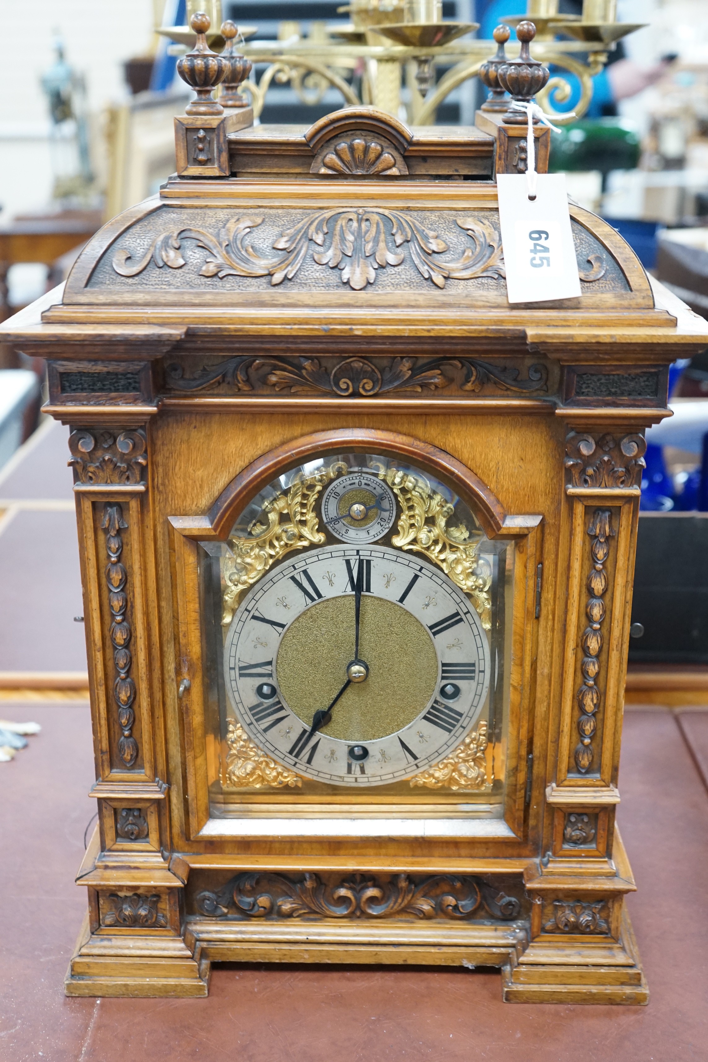 A 19th century architectural walnut bracket clock, with key and pendulum. 53cm tall